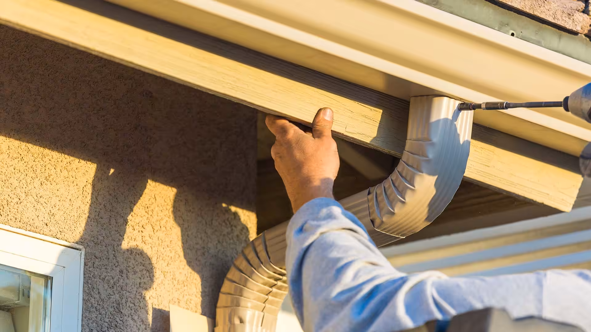 Professional seamless gutter installation on a Kansas City home